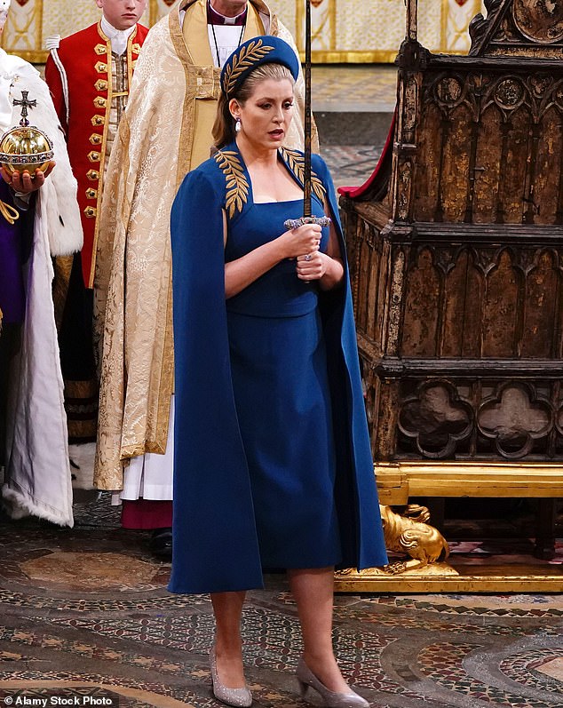 Leader of the House Penny Mordaunt wears a teal cape dress during the King's Coronation at Westminster Abbey in May