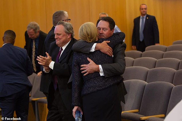 De Nitto hugs his wife after she was appointed prosecutor in 2019