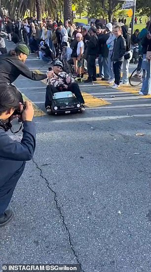 Footage from the event shows large crowds cheering as children and adults furiously rolled down the steep descent - some flying off their boards and hitting the pavement only to get back up to do it again