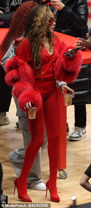 she completed the modern look with a silver chain, red glasses and matching high heels