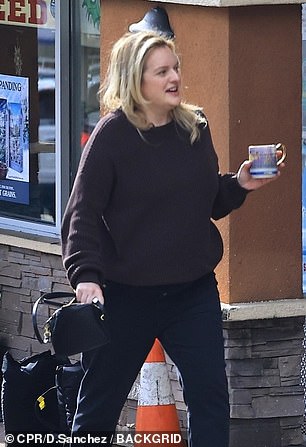 The beauty was seen holding a blue water bottle to help her stay hydrated.  At one point, she was also seen holding a glass cup in her hand as she walked outside