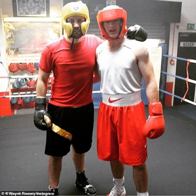 The four boys appear to be following in the footsteps of their father (pictured right with professional boxer Paul Smith), whose own love of the contact sport is well documented