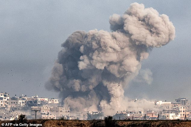 A plume of smoke erupts over the northern Gaza Strip during the Israeli bombardment from southern Israel on December 27, 2023, amid ongoing fighting between Israel and the Palestinian terrorist group Hamas