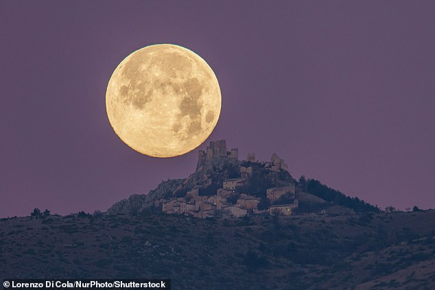 A cold full moon is seen here behind the castle and village of Rocca Calassio in Calassio, Italy, in the early hours of December 27, 2023.