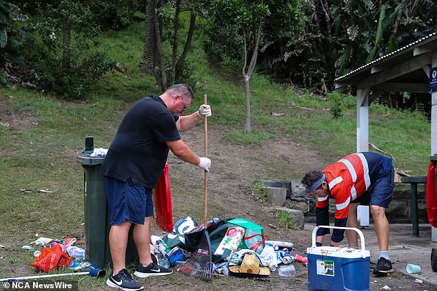 Robert Kokolich (left), a long-time resident of the beach area, assisted municipal staff in cleaning up the rubbish left behind by revelers