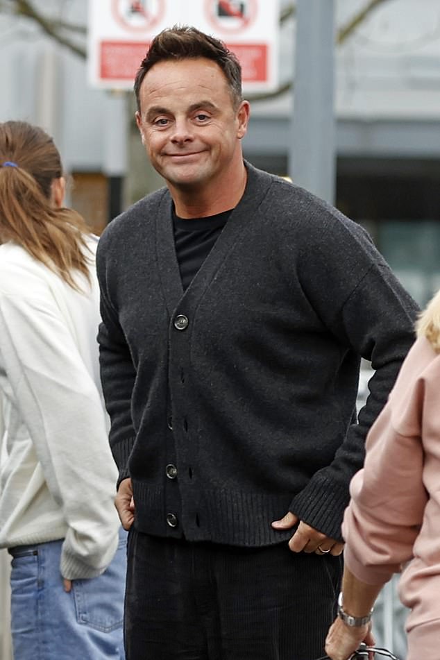 The beaming couple were pictured wearing matching cardigans at Heathrow airport with luggage in hand - it's not clear where they were flying to