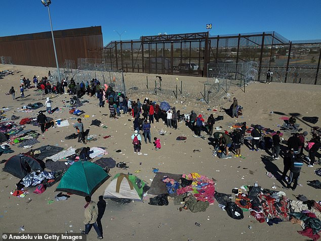 Migrants, mostly from Central and South America, wait near El Paso, Texas, for their turn to turn themselves over to U.S. Border Patrol for a chance to seek asylum in the United States