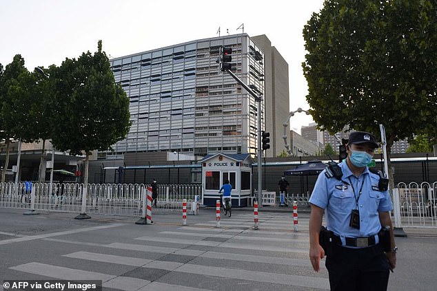 A Chinese police officer patrols outside the US Embassy in Beijing in a file photo