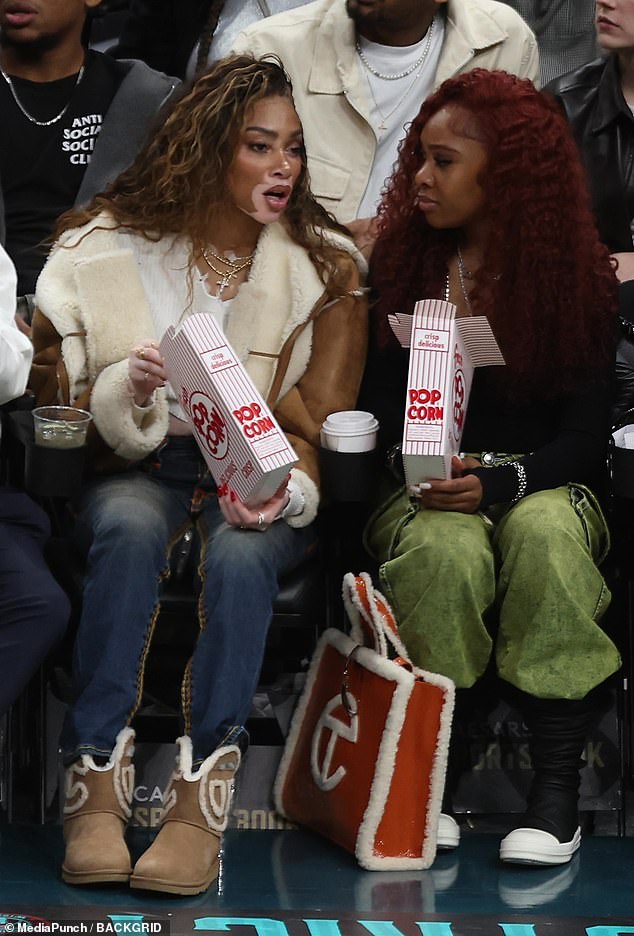 The fur-trimmed jacket paired perfectly with her fur-trimmed UGG boots as she enjoyed the front row with a gorgeous friend