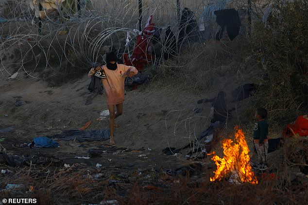 At Christmas, thousands of people spent the holiday season in shelters and camps.  To stay warm, some see fires starting at a camp in Ciudad Juarez, Mexico on December 28