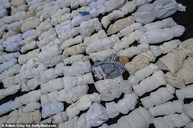 Effigies representing the thousands of children killed in Gaza are on display after people took part in a silent procession through Midtown Manhattan last night