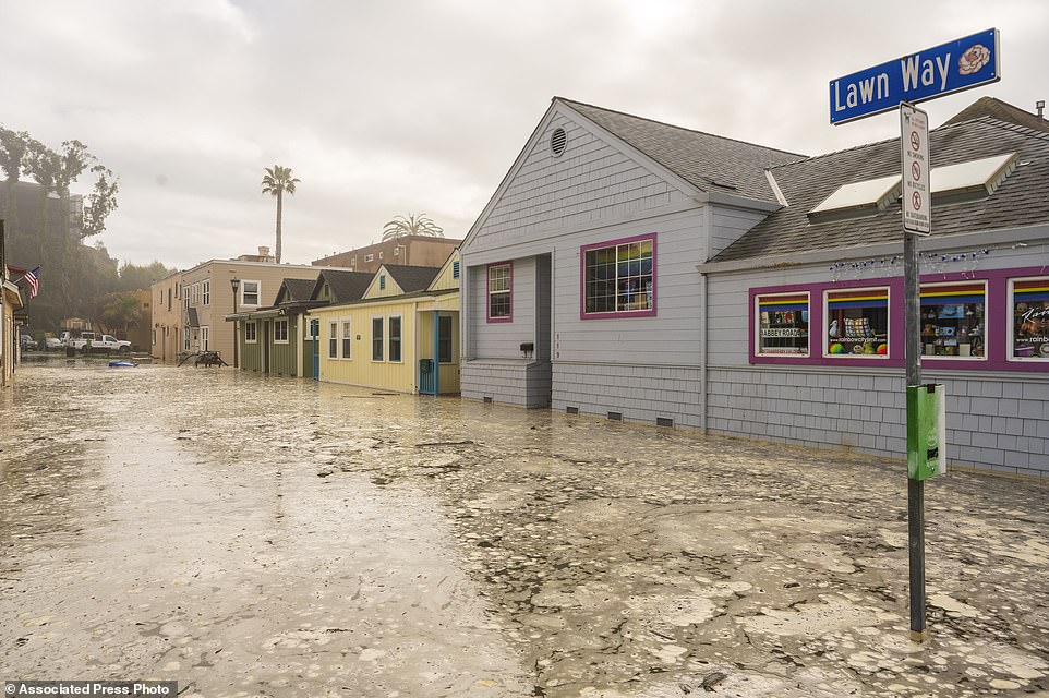 The streets in Capitola, California are flooded on Thursday.  Powerful surf rolls over the beaches of the West Coast and Hawaii as a large swell generated by the stormy Pacific Ocean pushes towards the coastline