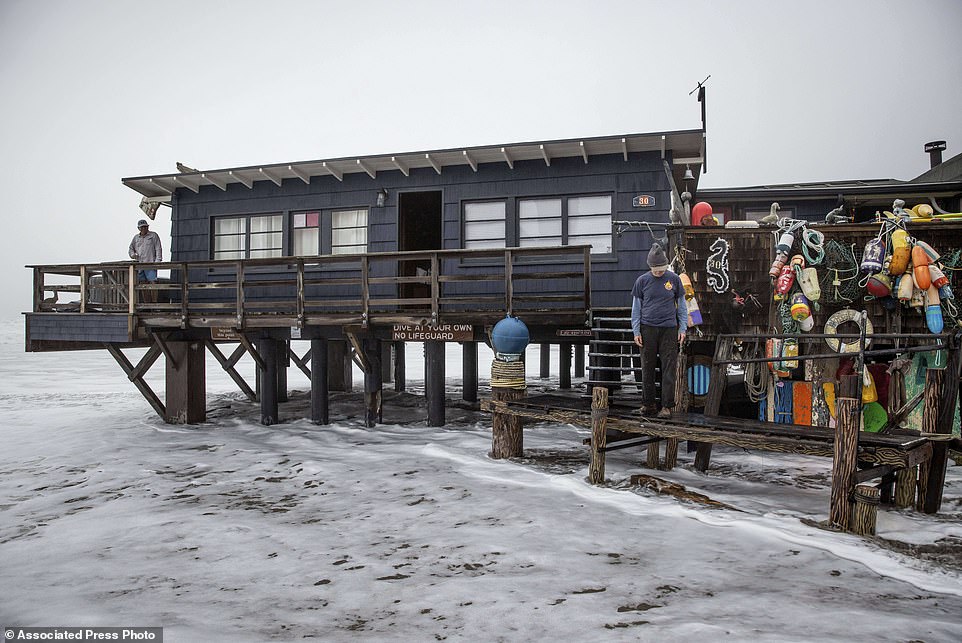 Waves splashed beneath a Stinson Beach home that was under an evacuation warning Thursday