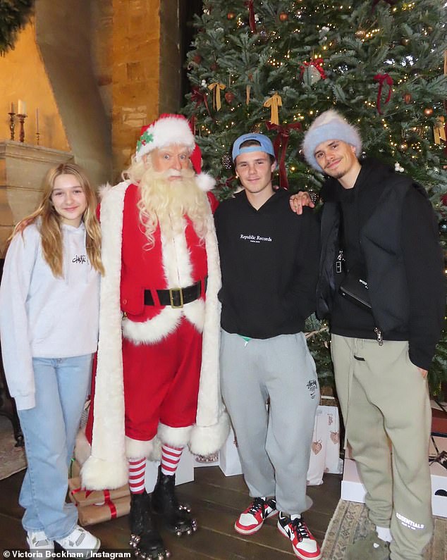 Their sons Romeo, 21 (right) and Cruz, 18 (second right), also had their photo taken with Santa, as did their daughter Harper, 12 (left)