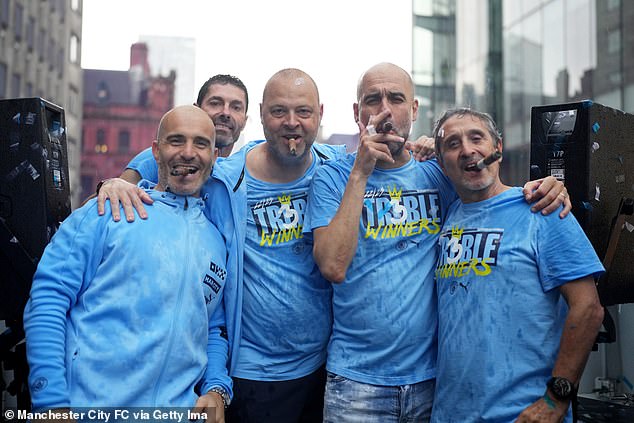 Pep Guardiola with his trusted team, including Estiarte (right), as they celebrate the Treble victory