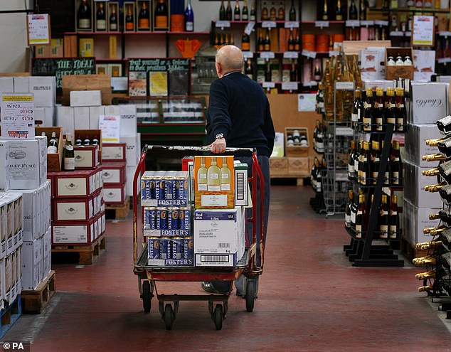 British shopper David Thomas from Kent fills his shopping cart with cheap wine and beer in Calais, France