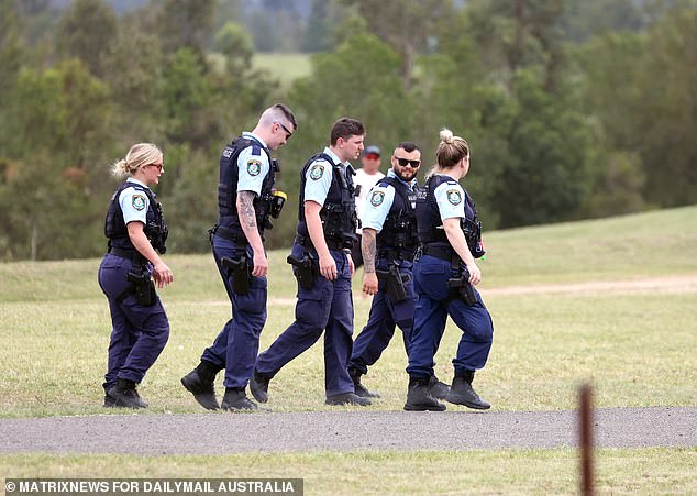 Five police officers were seen walking along the beach before promptly leaving