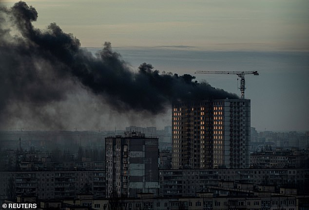 Smoke rises over a residential building after a Russian missile and drone attack in Kiev