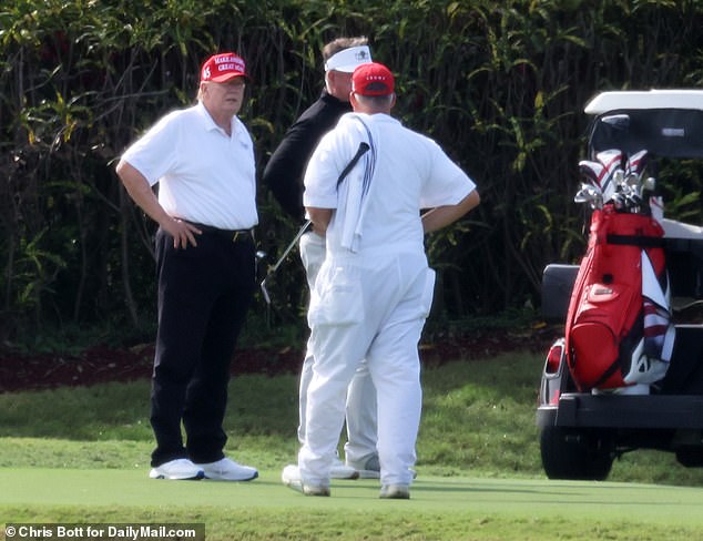 The former president talks to the staff at his golf club