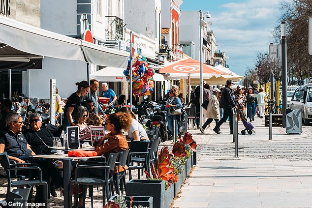 He foresaw the emergence of an artistic community.  Pictured are people relaxing on terraces in Olhao, Algarve, Portugal