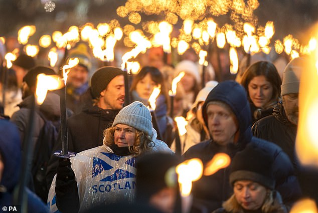 Some 20,000 torches lit up the streets in celebration of the 30th anniversary last night, with street theatre, fire performers, pipe bands and drummers providing entertainment