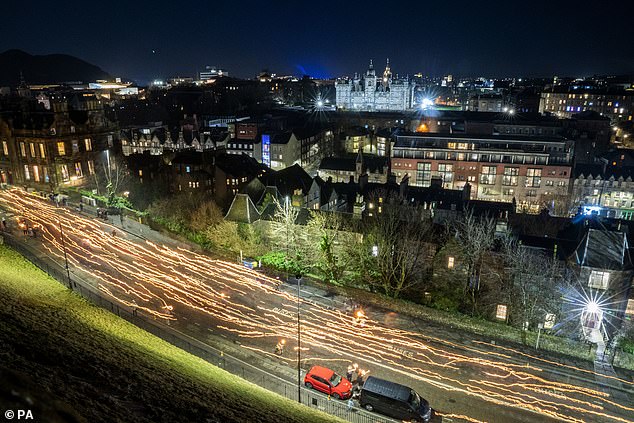 People during the torchlight procession in the center of Edinburgh.  Stephen Jamieson and Findlay Johnstone, both members of the South Mainland Up Helly Aa, were happy to be involved