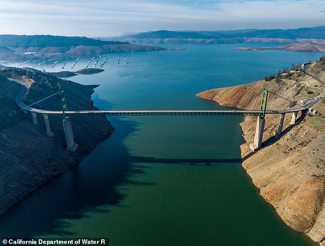 An image taken from a drone shows low water conditions at the Bidwell Bar Bridge on Lake Oroville in Butte County, California.  At this date, water storage was 1,042,146 acre-feet (AF), 29 percent of total capacity.  Photo taken December 21, 2022. Ken James / California Department of Water Resources, EDITORIAL USE ONLY