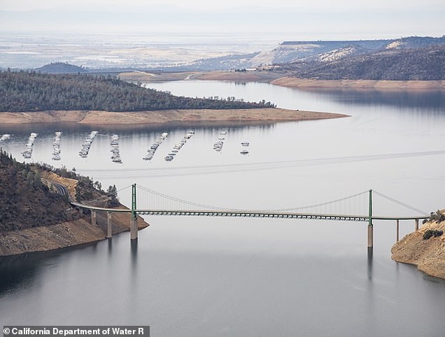 An aerial photo shows high water conditions at the Bidwell Bar Bridge on Lake Oroville in Butte County, California.  On this date, water storage was 3,524,311 acre-feet (AF), 100 percent of total capacity.  Photo taken June 12, 2023. Ken James / California Department of Water Resources