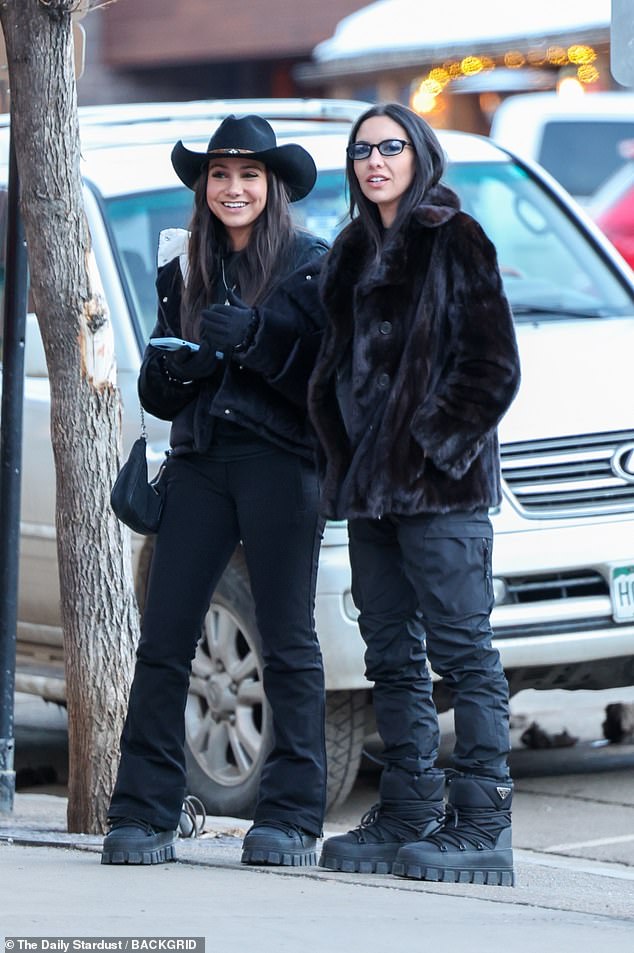 The TV and film producer looked like she stepped off the catwalk in her sophisticated black fur coat and matching ski trousers, appearing in good spirits alongside a group of friends.