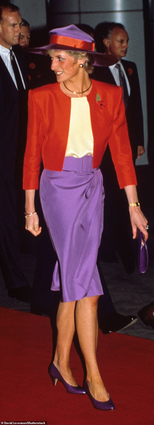 Princess Diana wore a purple pencil skirt, a short red jacket and a purple booter with red trim when she arrived in Hong Kong in 1989