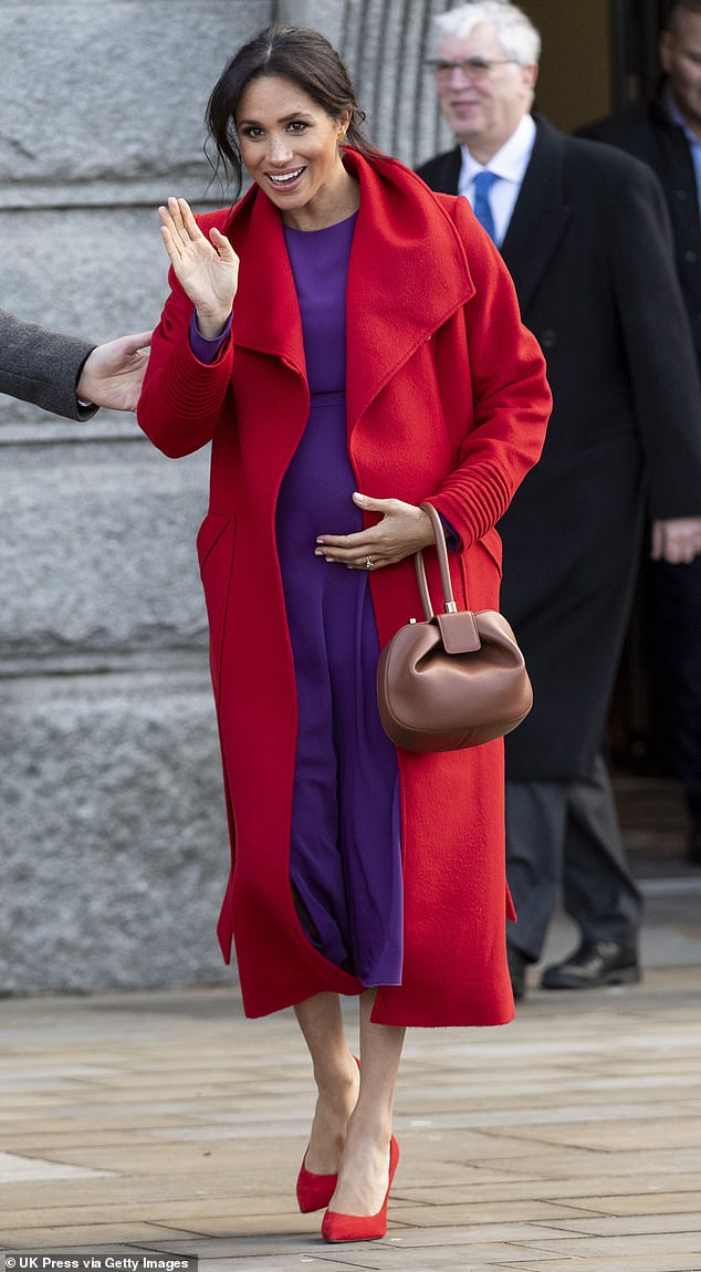 Meghan wears a purple and red combination to mark the 100th anniversary of Wilfred Owen's death in 2019