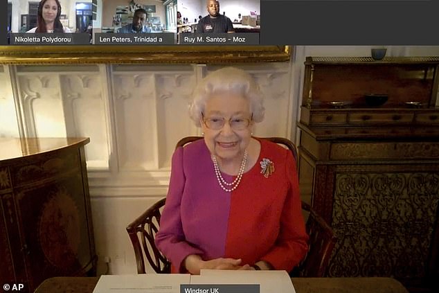 Red and purple for Queen Elizabeth II as she takes a video call during the pandemic in 2020