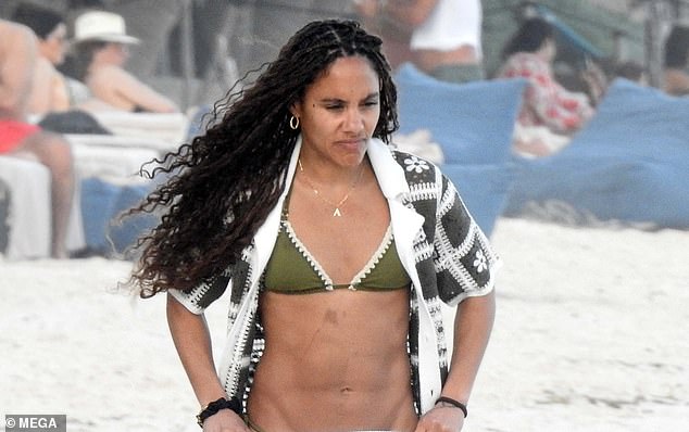 The former Arsenal star showed off her stunning abs in an olive-colored two-piece