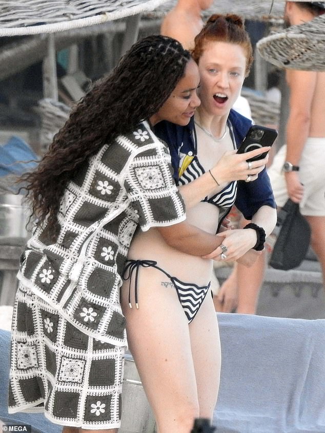 Jess showed off her figure in a black and white bikini and Jess was seen bursting into laughter as she responded to something funny on Alex's phone.
