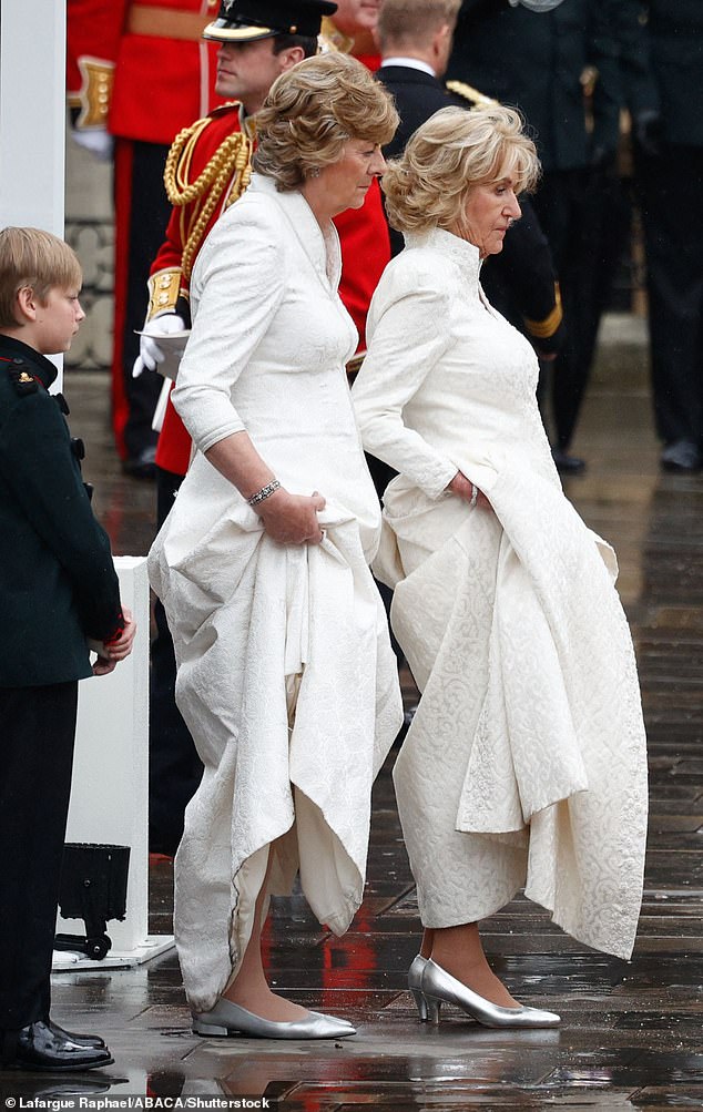 Annabel Elliot keeps her Fiona Clare dress out of the puddles on coronation day