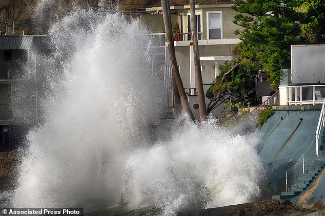 Strong surf was seen hitting beachfront homes in Malibu on Friday