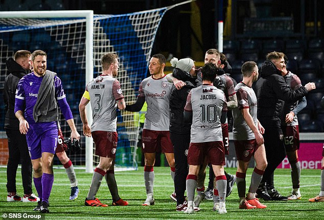 He was mobbed at full-time by his teammates as they applauded the visiting fans - who chanted Adams' name