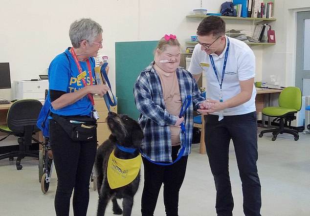 And Evie eventually made enough progress to take her first steps with Poppy on the leash.  Evie's mother, Sara Evans, said: 'It was an amazing moment.  It was thanks to Poppy that Evie stood next to her at the parallel bars for the first time.  Poppy made Evie do things she otherwise wouldn't have done – we call it Poppy power'