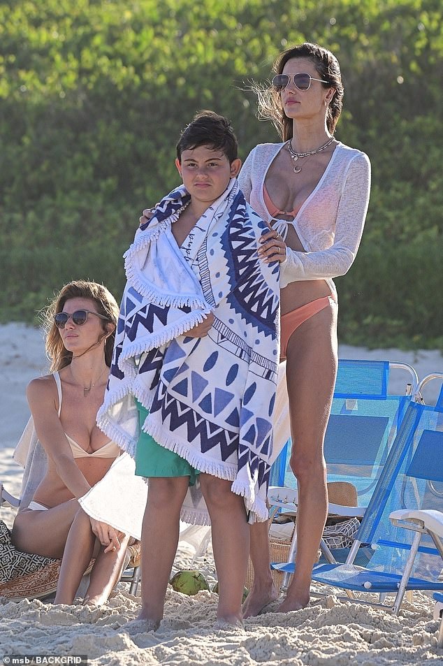 Alessandra was accompanied by her adorable 11-year-old son Noah, who smiled as she wrapped her arms around him with a towel