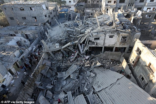 Palestinians inspect damage after Israeli attacks on the Zawayda area in the central Gaza Strip