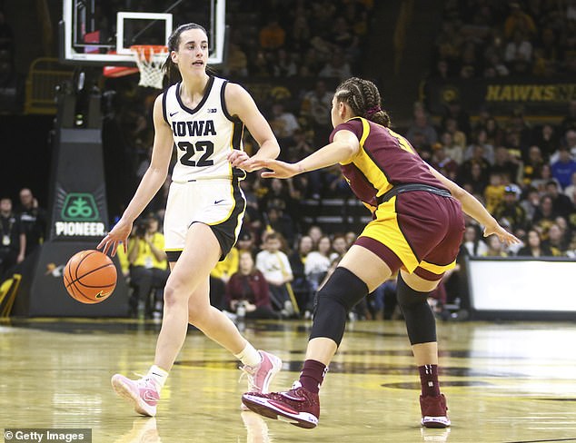 Guard Caitlin Clark #22 of the Iowa Hawkeyes drives down the court against guard Amaya Battle #3 of the Minnesota Gophers in the second half on Saturday