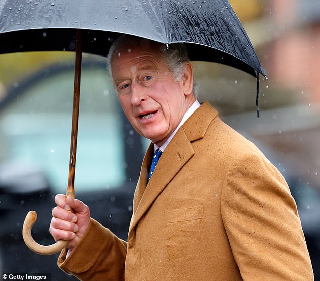 King Charles III takes shelter under an umbrella as he celebrates his 75th birthday