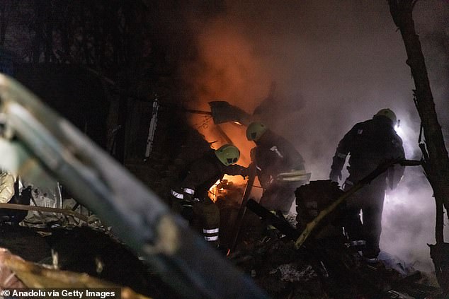 Rescue workers work at the site where an apartment building was severely damaged by a Russian missile attack