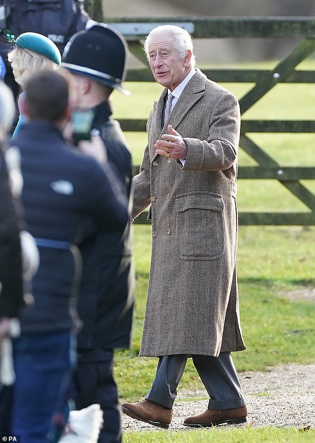 The king kept his outfit simple: a long, dark brown coat and blue trousers