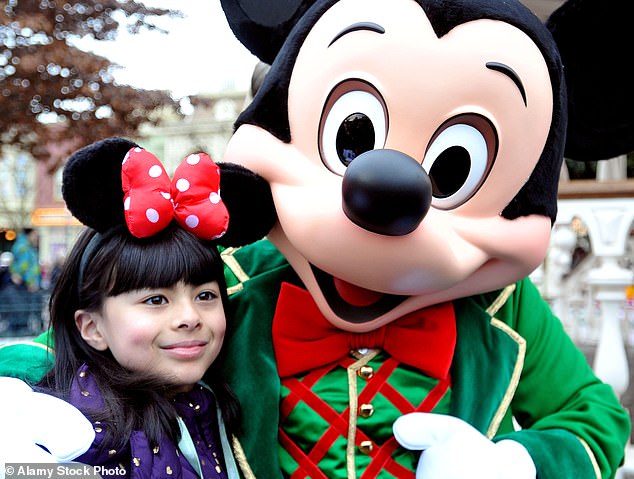 Mickey Mouse roams the Disneyland resorts and poses for photos with fans