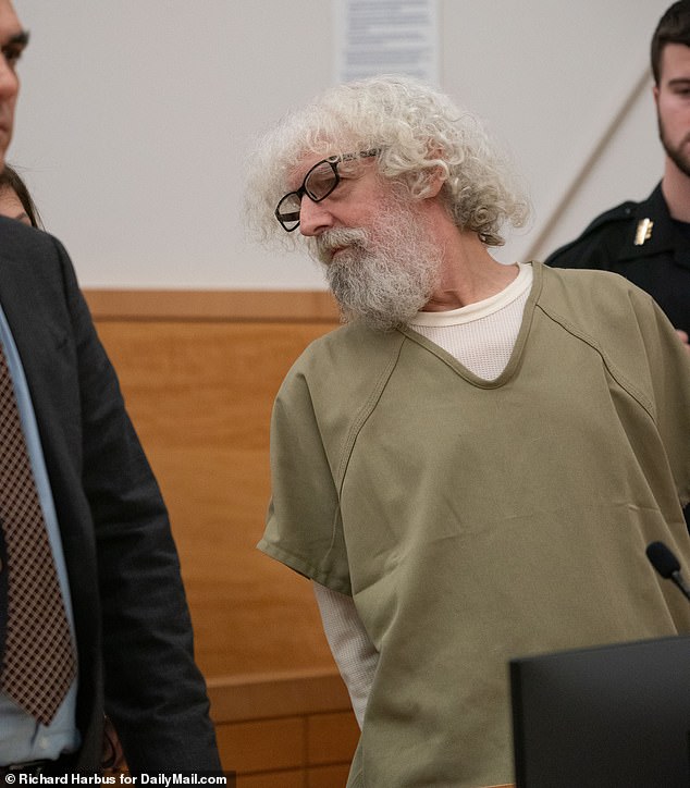 Steven Attanasso, the 'nightmare neighbor' accused of terrorizing his black neighbors, smiled as he was escorted into a New York City courtroom for a bail hearing on Wednesday