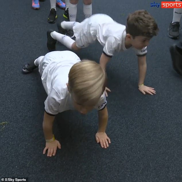 The adorable sweetheart was a giant ball of energy as he passionately completed a set of push-ups - and even managed to inspire another young mascot