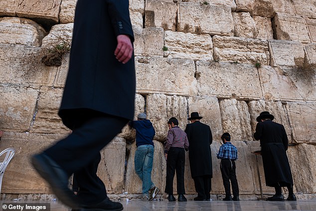 Men pray at the Western Wall in Jerusalem's Old City as tensions between Israel and Hamas continue to rise