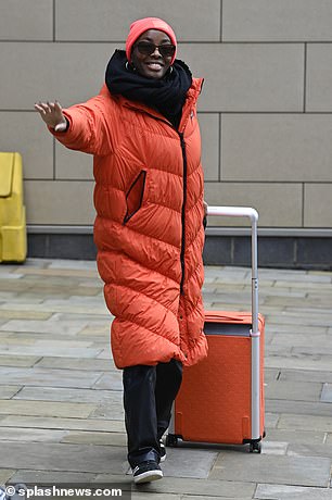 AJ Odudu dressed warmly as she arrived to film an upcoming celebrity special of the new Wheel of Fortune reboot on Friday
