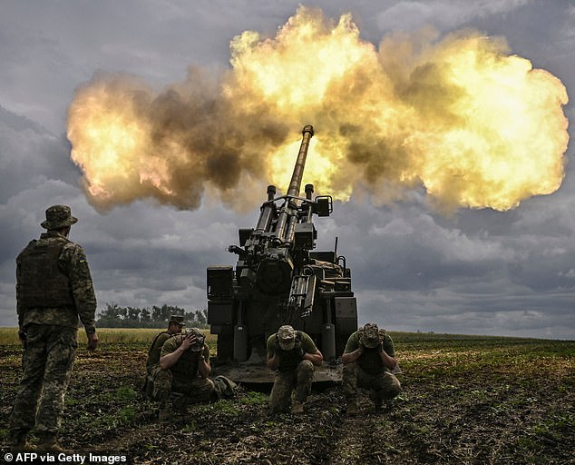 Ukrainian soldiers fire on Russian frontline positions in the eastern Donbas region